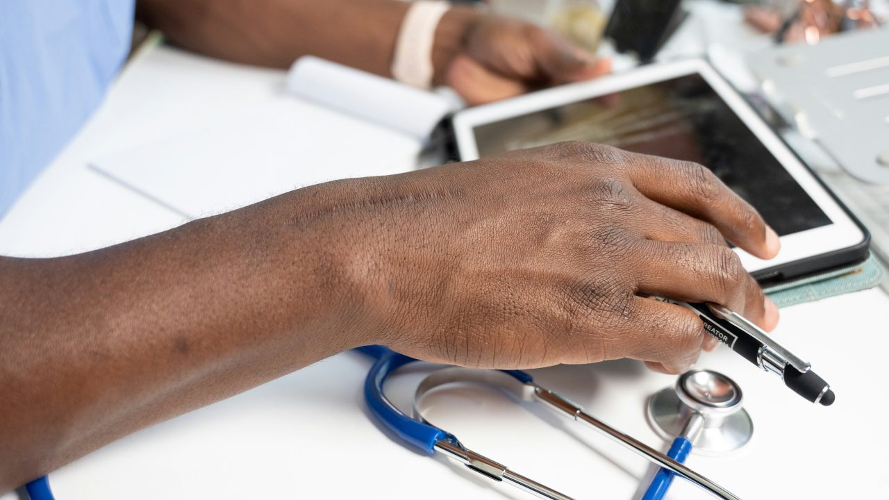 close up of nurse's hands on a tablet