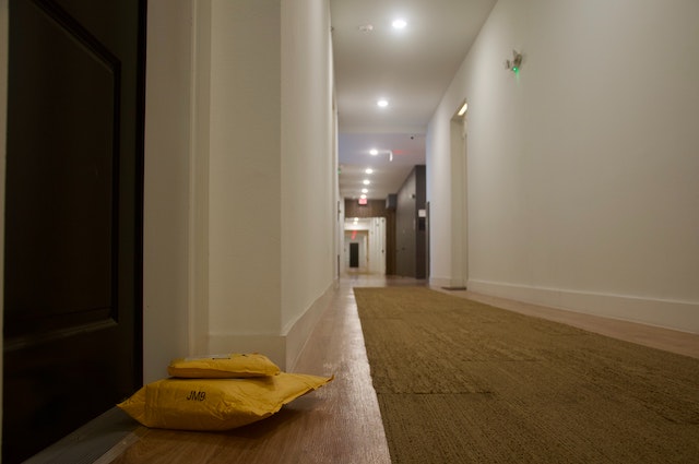 packages left outside door in a long hallway