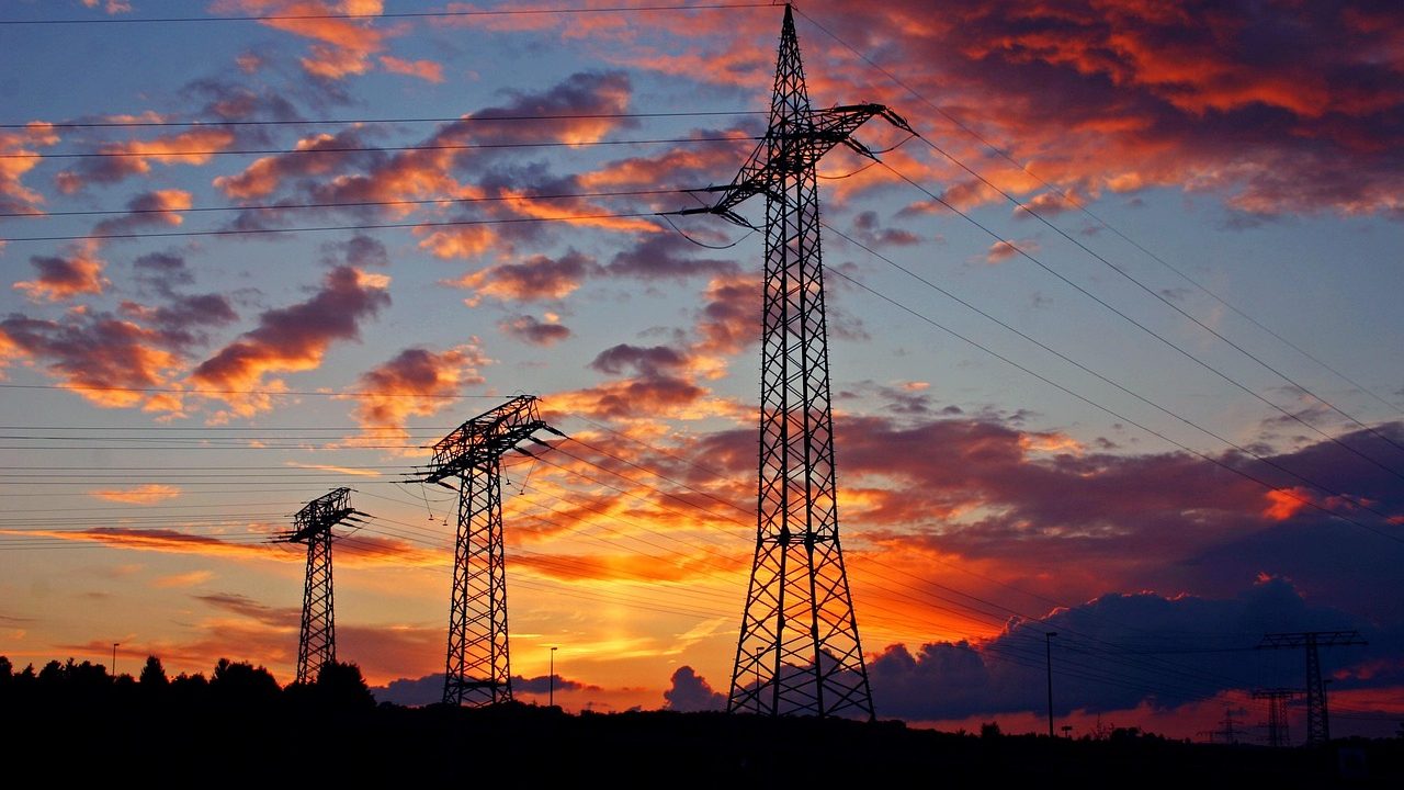 view of the sunset with electric poles silhouetted against the sky