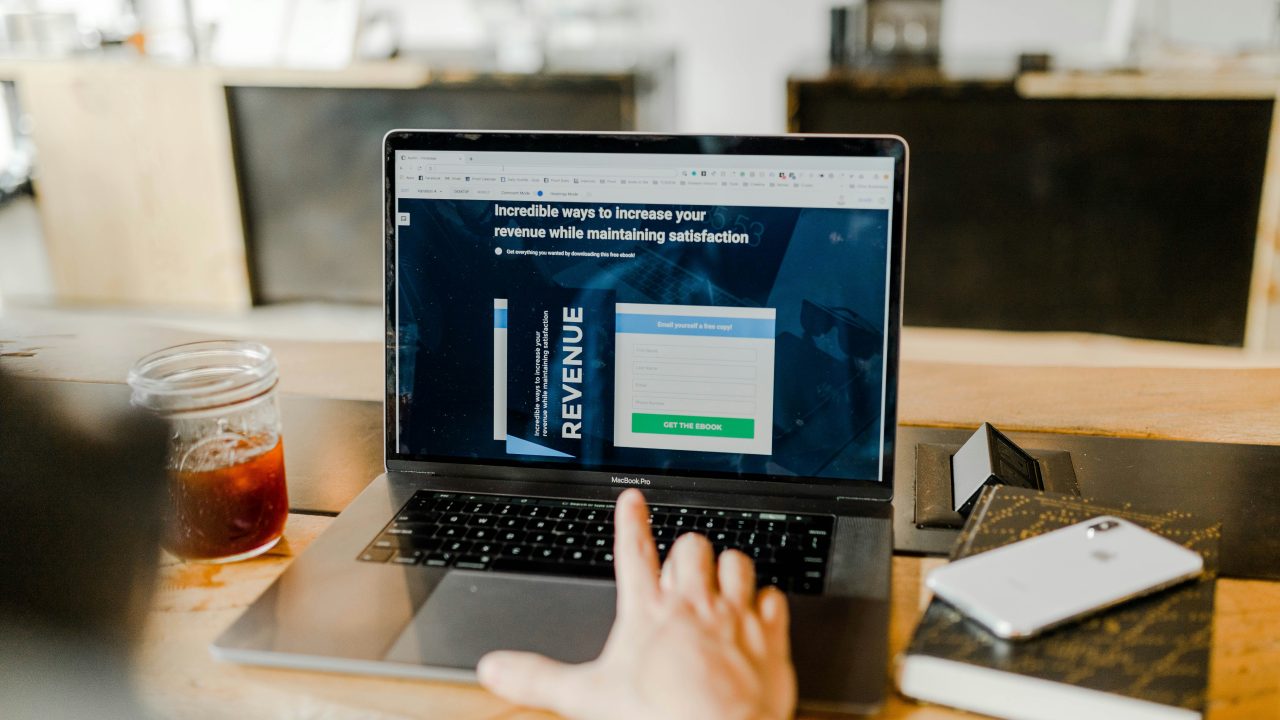 close up of hand over a laptop with a screen on a revenue form