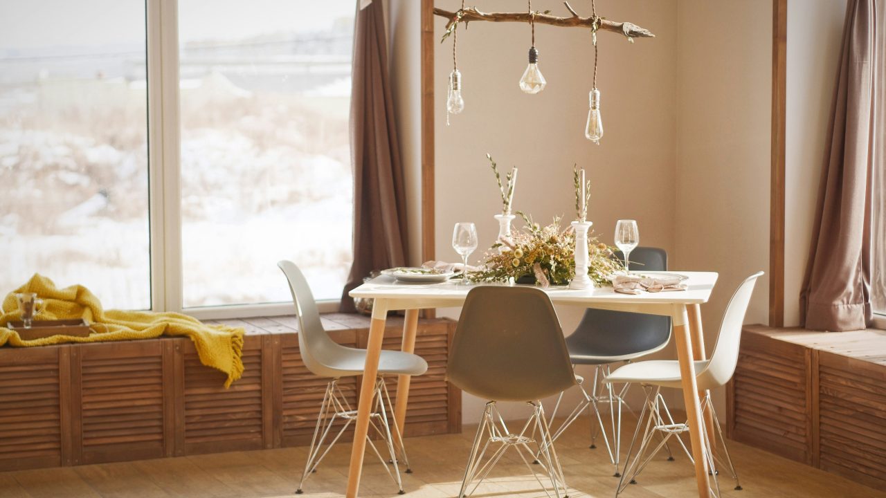 dining room with 3 modern chairs featuring a lightbulb chandelier dangling overhead