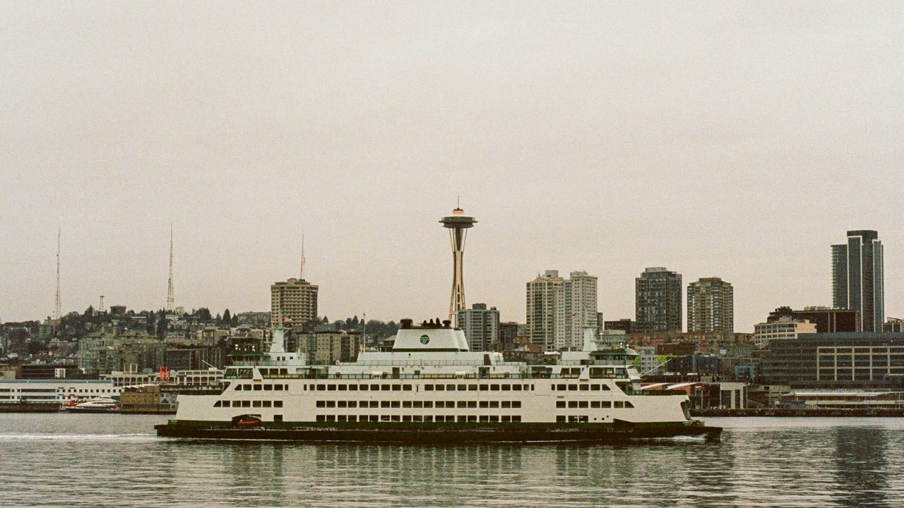 seattle ferry in front of space needle