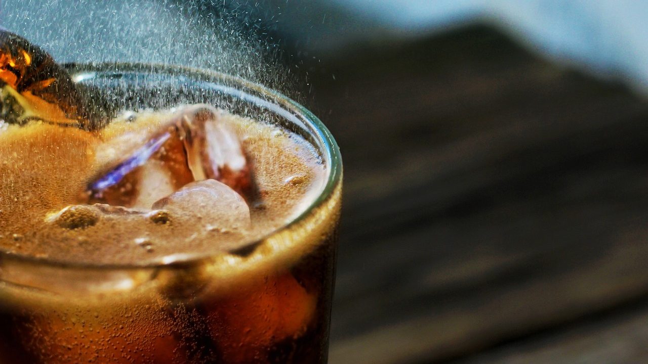 close up of a glass of soda filled with ice